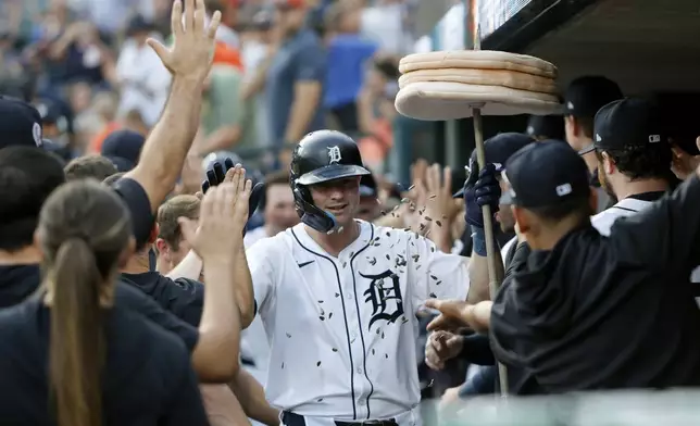 Detroit Tigers' Trey Sweeney celebrates in the dugout after hitting a three-run home run against the Colorado Rockies during the first inning of a baseball game, Wednesday, Sept. 11, 2024, in Detroit. (AP Photo/Duane Burleson)