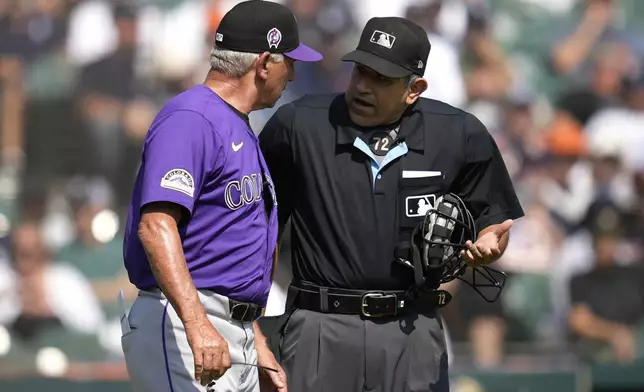 Colorado Rockies manager Bud Black, left, argues with home plate umpire Alfonso Marquez in the fourth inning of a baseball game against the Detroit Tigers, Thursday, Sept. 12, 2024, in Detroit. (AP Photo/Paul Sancya)