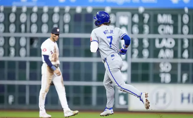 Kansas City Royals' Bobby Witt Jr. (7) rounds the bases after hitting a solo home run as Houston Astros shortstop Jeremy Pena, back left, watches during the eighth inning of a baseball game, Saturday, Aug. 31, 2024, in Houston. (AP Photo/Eric Christian Smith)