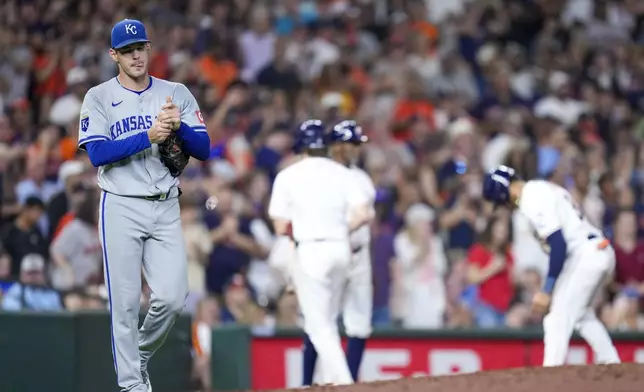 Kansas City Royals starting pitcher Cole Ragans, left, walks back to the mound after Houston Astros' Jeremy Pena, back right, hit a 2-run triple during the sixth inning of a baseball game Saturday, Aug. 31, 2024, in Houston. (AP Photo/Eric Christian Smith)