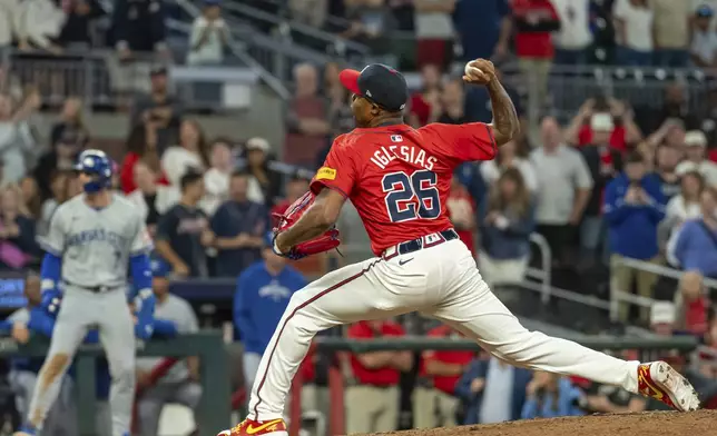 Atlanta Braves pitcher Raisel Iglesias throws in the ninth inning of a baseball game against the Kansas City Royals, Friday, Sept. 27, 2024, in Atlanta. (AP Photo/Jason Allen)