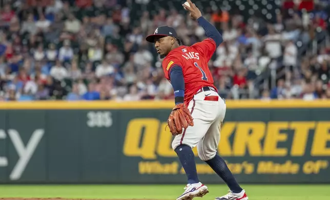 Atlanta Braves second baseman Ozzie Albies prepares to throw out Kansas City Royals' Tommy Pham at first base in the eighth inning of a baseball game, Friday, Sept. 27, 2024, in Atlanta. (AP Photo/Jason Allen)