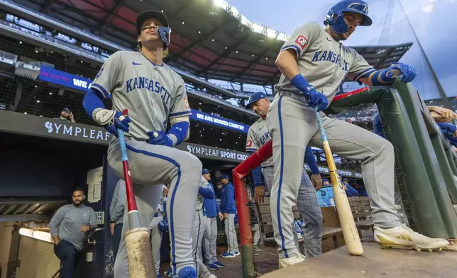 Kansas City Royals' Bobby Witt Jr., lfront eft, and Michael Massey, right, await for their turns at bat in the first inning of a baseball game against the Atlanta Braves, Friday, Sept. 27, 2024, in Atlanta. (AP Photo/Jason Allen)