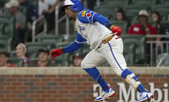 Atlanta Braves' Ozzie Albies watches his hit in the infield in the first inning of a baseball game against the Kansas City Royals, Saturday, Sept. 28, 2024, in Atlanta. (AP Photo/Jason Allen)