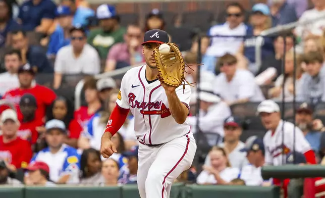 Atlanta Braves first baseman Matt Olson catches a throw before Kansas City Royals' Bobby Witt Jr. can reach first base in the fifth inning of a baseball game, Sunday, Sept. 29, 2024, in Atlanta. (AP Photo/Jason Allen)