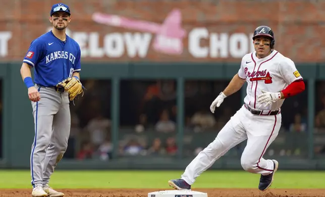 Atlanta Braves' Travis d'Arnaud, right, tags second base after a hit by Atlanta Braves catcher Sean Murphy while Kansas City Royals second baseman Michael Massey, left, waits for the throw to him in the fourth inning of a baseball game, Sunday, Sept. 29, 2024, in Atlanta. (AP Photo/Jason Allen)