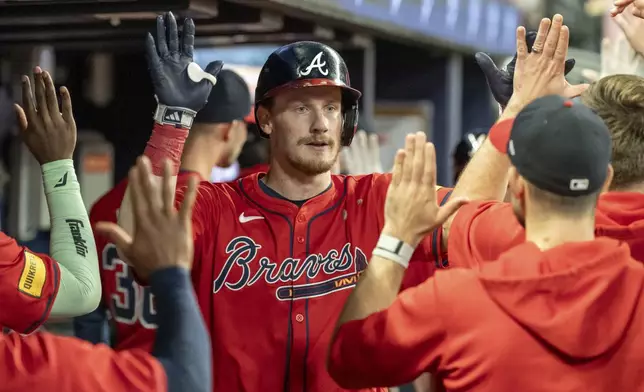 Atlanta Braves' Sean Murphy, center, celebrates in the dugout after hitting a two-run home run in the fourth inning of a baseball game against the Kansas City Royals, Friday, Sept. 27, 2024, in Atlanta. (AP Photo/Jason Allen)