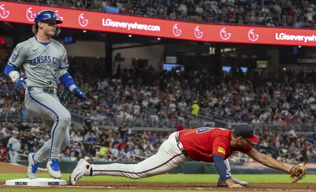 Kansas City Royals' Bobby Witt Jr., left, tags first base before Atlanta Braves first baseman Matt Olson, right, stretches out to field the throw in the third inning of a baseball game, Friday, Sept. 27, 2024, in Atlanta. (AP Photo/Jason Allen)