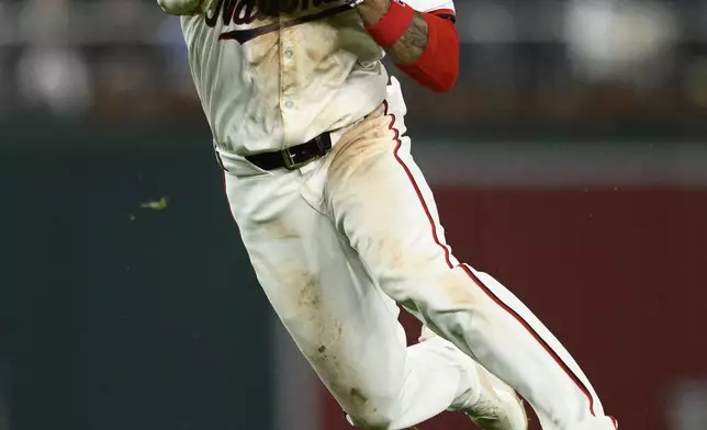 Washington Nationals shortstop Nasim Nunez throws to first to put out Kansas City Royals' Bobby Witt Jr. during the seventh inning of a baseball game, Tuesday, Sept. 24, 2024, in Washington. (AP Photo/Nick Wass)