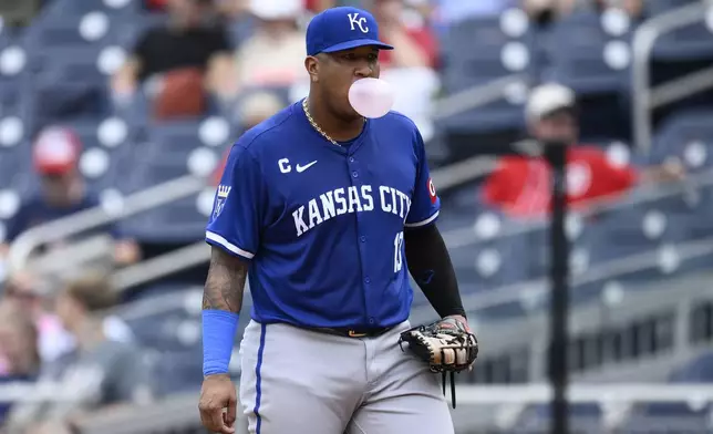 Kansas City Royals first base Salvador Perez stands by first base as he blows a bubble during the third inning of a baseball game against the Washington Nationals, Thursday, Sept. 26, 2024, in Washington. (AP Photo/Nick Wass)