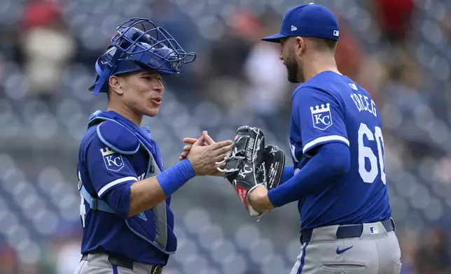 Kansas City Royals catcher Freddy Fermin, left, and relief pitcher Lucas Erceg (60) celebrate after a baseball game against the Washington Nationals, Thursday, Sept. 26, 2024, in Washington. The Royals won 7-4. (AP Photo/Nick Wass)