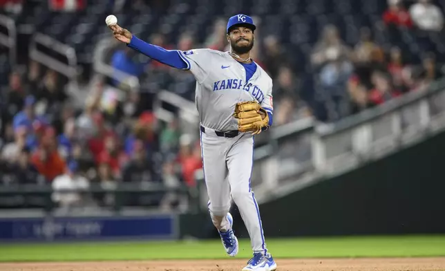 Kansas City Royals third baseman Maikel Garcia throws to first to put out Washington Nationals' James Wood during the third inning of a baseball game, Tuesday, Sept. 24, 2024, in Washington. (AP Photo/Nick Wass)