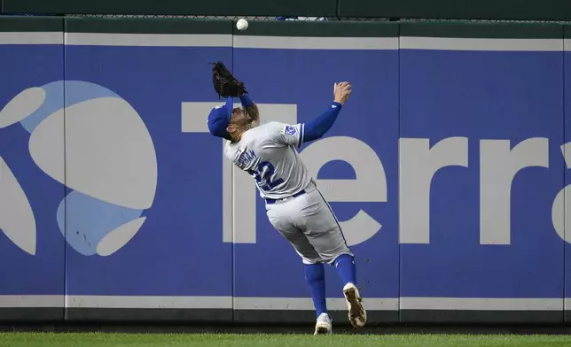 Kansas City Royals left fielder Tommy Pham (22) makes a catch on a fly ball by Washington Nationals' Luis Garcia Jr. for an out during the fourth inning of a baseball game, Tuesday, Sept. 24, 2024, in Washington. (AP Photo/Nick Wass)