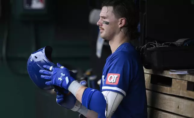 Kansas City Royals' Bobby Witt Jr. looks on from the dugout during the fourth inning of a baseball game against the Washington Nationals, Thursday, Sept. 26, 2024, in Washington. (AP Photo/Nick Wass)