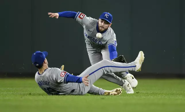 Kansas City Royals center fielder Kyle Isbel, top, and second baseman Michael Massey, bottom, lunge for a fly ball hit for a double by Washington Nationals' Jacob Young during the seventh inning of a baseball game, Tuesday, Sept. 24, 2024, in Washington. (AP Photo/Nick Wass)