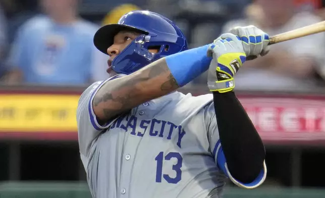 Kansas City Royals' Salvador Perez (13) follows through on a two-run home run off Pittsburgh Pirates starting pitcher Luis L. Ortiz during the second inning of a baseball game in Pittsburgh, Friday, Sept. 13, 2024. (AP Photo/Gene J. Puskar)