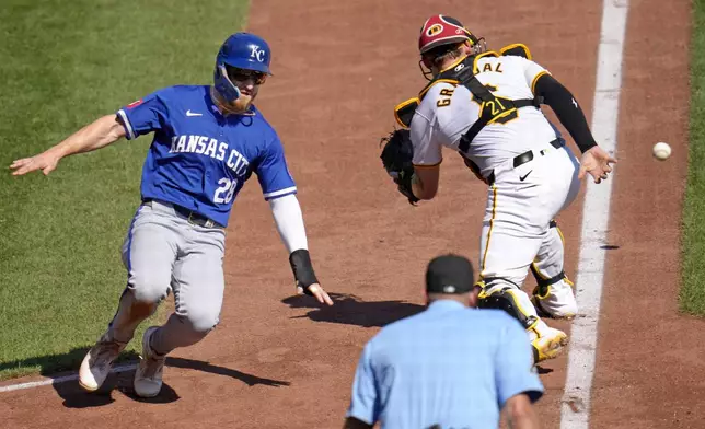 Kansas City Royals' Kyle Isbel (28) scores around Pittsburgh Pirates catcher Yasmani Grandal on a error by centerfielder Oneil Cruz on a ball hit by Bobby Witt Jr. during the seventh inning of a baseball game in Pittsburgh, Saturday, Sept. 14, 2024. (AP Photo/Gene J. Puskar)