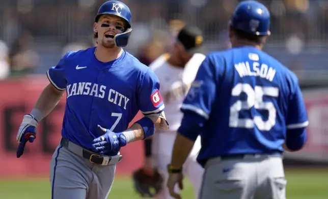 Kansas City Royals' Bobby Witt Jr. (7) rounds third to greetings from third base coach Vance Wilson (25) after hitting a solo home run off Pittsburgh Pirates starting pitcher Mitch Keller during the first inning of a baseball game in Pittsburgh, Saturday, Sept. 14, 2024. (AP Photo/Gene J. Puskar)