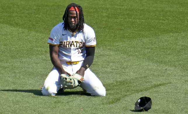 Pittsburgh Pirates centerfielder Oneil Cruz collects himself after diving for and failing to catch a triple hit by Kansas City Royals' Adam Frazier during the fifth inning of a baseball game in Pittsburgh, Saturday, Sept. 14, 2024. (AP Photo/Gene J. Puskar)