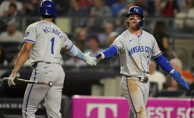 Kansas City Royals' Bobby Witt Jr., right, celebrates with MJ Melendez (1) after scoring on a single hit by Salvador Perez during the third inning of a baseball game at Yankee Stadium, Tuesday, Sept. 10, 2024, in New York. (AP Photo/Seth Wenig)