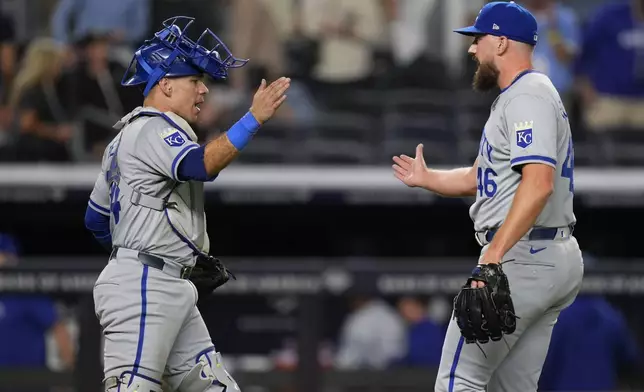 Kansas City Royals catcher Freddy Fermin, left, and pitcher John Schreiber celebrate after a baseball game against the New York Yankees at Yankee Stadium Tuesday, Sept. 10, 2024, in New York. (AP Photo/Seth Wenig)