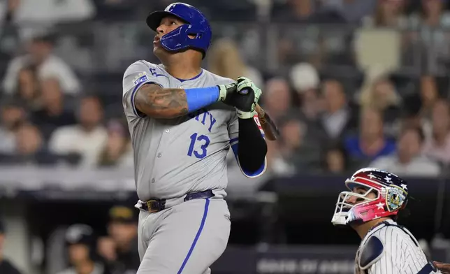 Kansas City Royals' Salvador Perez (13), left, and New York Yankees catcher Jose Trevino look after a sacrifice fly during the seventh inning of a baseball game at Yankee Stadium, Wednesday, Sept. 11, 2024, in New York. (AP Photo/Seth Wenig)