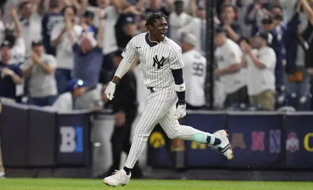 New York Yankees' Jazz Chisholm Jr. celebrates after hitting a walk-off RBI single during the 11th inning of a baseball game against the Kansas City Royals at Yankee Stadium Wednesday, Sept. 11, 2024, in New York. (AP Photo/Seth Wenig)