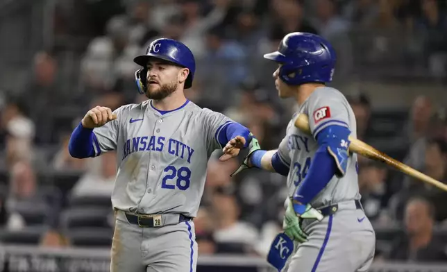 Kansas City Royals' Kyle Isbel (28), left, celebrates with Freddy Fermin after scoring on a sacrifice fly hit by Salvador Perez during the seventh inning of a baseball game at Yankee Stadium, Wednesday, Sept. 11, 2024, in New York. (AP Photo/Seth Wenig)