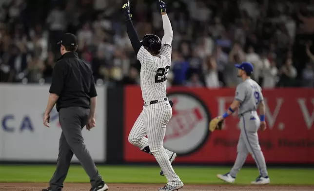 New York Yankees' Juan Soto, center, celebrates after hitting a two-run home run during the sixth inning of a baseball game against the Kansas City Royals at Yankee Stadium, Wednesday, Sept. 11, 2024, in New York. (AP Photo/Seth Wenig)