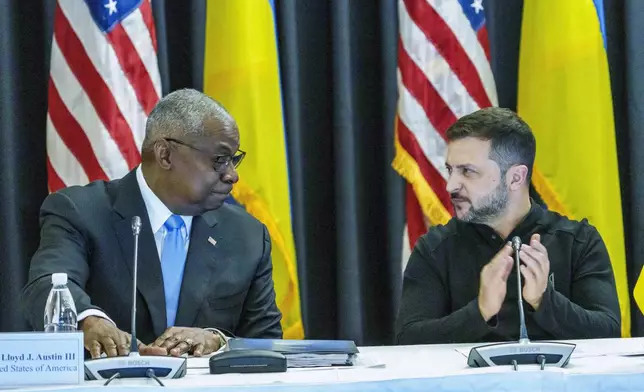 Defense Secretary Lloyd Austin, left and Ukrainian President Volodymyr Zelenskyy look at each other during the Ukraine Contact Group meeting at Ramstein Air Base, Friday, Sept.6, 2024. (Andreas Arnold/dpa via AP)