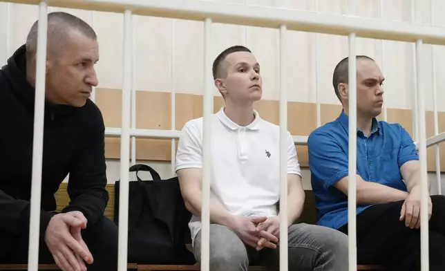 Former Navalny's lawyers Igor Sergunin, from left, Alexei Liptser and Vadim Kobzev sit in the cage during a court session in Petushki, Vladimir region, about 120 kilometers (75 miles) east of Moscow, Russia, Thursday, Sept. 12, 2024. (AP Photo/Alexander Zemlianichenko)