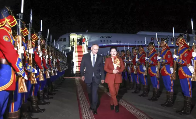 Russian President Vladimir Putin, on red carpet left, walks next to Mongolian Foreign Minister of Mongolia, Batmunkh Battsetseg upon his arrival at Ulaanbaatar's International airport Chinggis Khaan, late Monday, Sept. 2, 2024. (Natalia Gubernatorova, Sputnik, Kremlin Pool Photo via AP)