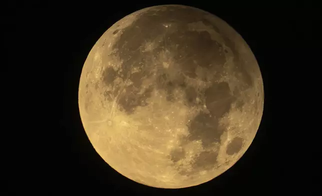 The full Harvest supermoon is seen over Moscow, Russia, Wednesday, Sept. 18, 2024. (AP Photo/Alexander Zemlianichenko)