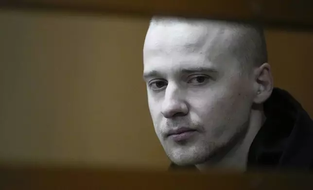 Alexander Permyakov, a Ukrainian national standing trial over a car bombing that injured well-known nationalist novelist and ardent Kremlin supporter Zakhar Prilepin, sits in a glass cage in a courtroom prior to a session in the Russian Military Court in Moscow, Russia, Monday, Sept. 30, 2024. (AP Photo/Alexander Zemlianichenko)