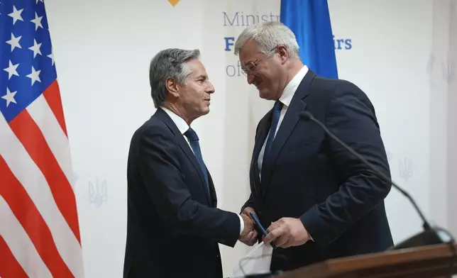 U.S. Secretary of State Antony Blinken, left, greets Ukraine's Foreign Minister Andriiy Sybiha at the end of a joint news conference with Britain's Foreign Secretary David Lammy at the Ministry of Foreign Affairs in Kyiv, Ukraine, Wednesday, Sept. 11, 2024. (AP Photo/Efrem Lukatsky)