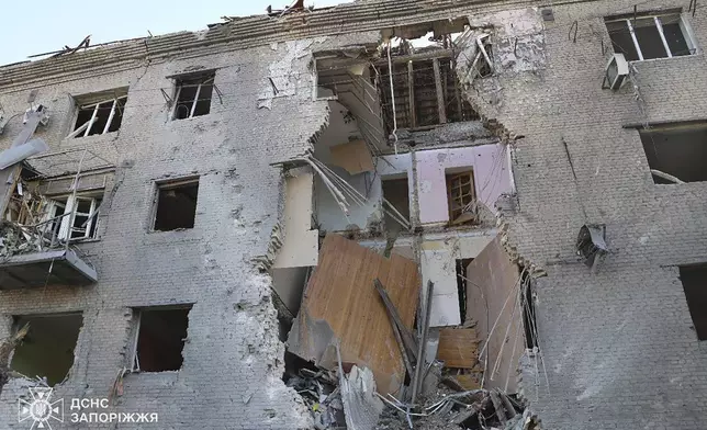 In this photo provided by the Ukrainian Emergency Service, a damaged apartment house is seen after Russia attacked the city with guided bombs overnight in Zaporizhzhia, Ukraine, Sunday, Sept. 29, 2024. (Ukrainian Emergency Service via AP)