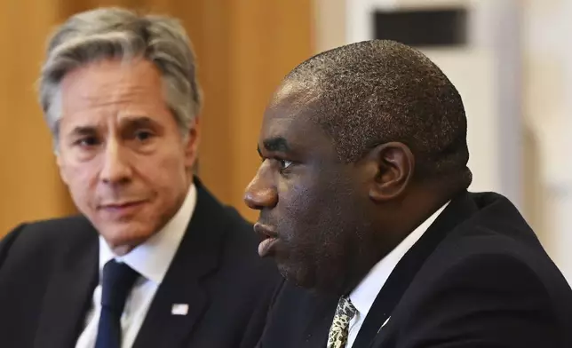 US Secretary of State Antony Blinken, left, listens as UK Foreign Secretary David Lammy, right, speaks during the Fourth Crimea Platform Leaders Summit in Kyiv, Ukraine, Wednesday, Sept. 11, 2024. (Leon Neal/Pool via AP)