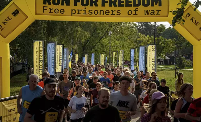 People participate a charity run to raise awareness on Ukrainian prisoners of war held by Russia, in Kyiv, Ukraine, Saturday, Sept. 14, 2024. (AP Photo/Evgeniy Maloletka)