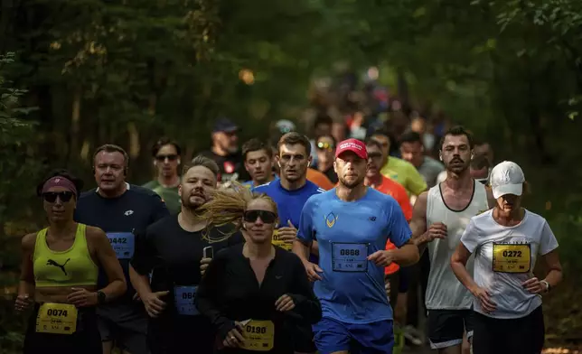 People participate a charity run to raise awareness on Ukrainian prisoners of war held by Russia, in Kyiv, Ukraine, Saturday, Sept. 14, 2024. (AP Photo/Evgeniy Maloletka)