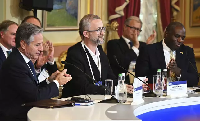 Front from left, US Secretary of State, Antony Blinken, Deputy Chairman of the Mejlis of the Crimean Tatar Nariman Dzhelyal and British Foreign Secretary David Lammy attend the Fourth Crimea Platform Leaders Summit in Kyiv, Ukraine, Wednesday, Sept. 11, 2024. (Leon Neal/Pool via AP)