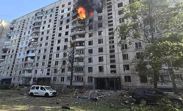 Flames rise and debris is scattered on the ground after a Russian aerial bomb struck a multi-story residential building in Kharkiv, Ukraine, Sunday Sept. 15, 2024. (Ukrainian Presidential Press Office via AP)