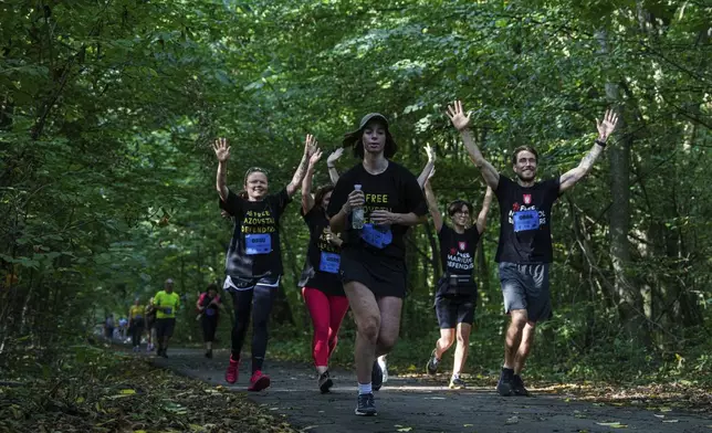 People participate a charity run to raise awareness on Ukrainian prisoners of war held by Russia, in Kyiv, Ukraine, Saturday, Sept. 14, 2024. (AP Photo/Evgeniy Maloletka)