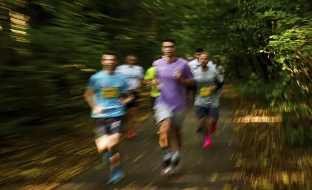 People participate a charity run to raise awareness on Ukrainian prisoners of war held by Russia, in Kyiv, Ukraine, Saturday, Sept. 14, 2024. (AP Photo/Evgeniy Maloletka)