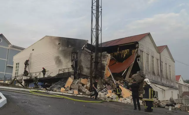 Firefighters extinguish a fire after a rocket hit a building of a higher education institution in the Ukrainian capital Kyiv, Monday, Sept. 2, 2024..(AP Photo/Vasilisa Stepanenko)