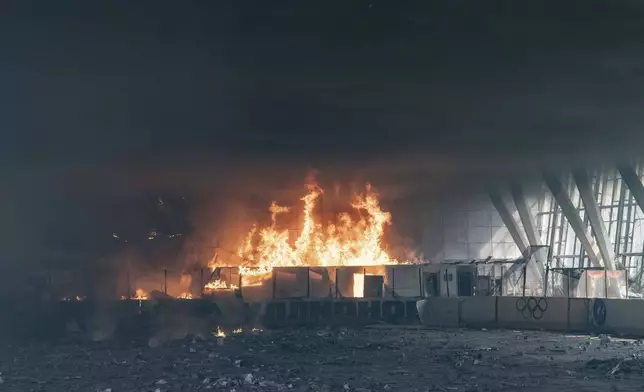 A fire burns at a sports facility destroyed after Russian attack in Kharkiv, Ukraine, Sunday, Sept. 1 2024. (AP Photo/Yevhen Titov)