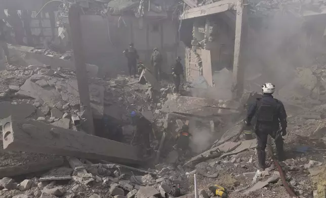 Rescue workers clear the rubble at a sports facility destroyed after Russian attack in Kharkiv, Ukraine, Sunday, Sept. 1 2024. (AP Photo/Yevhen Titov)