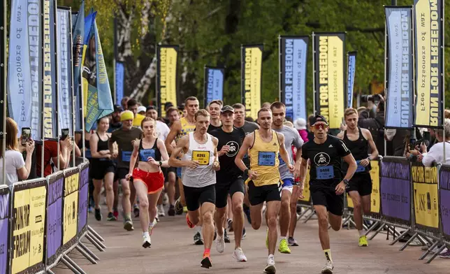 People participate a charity run to raise awareness on Ukrainian prisoners of war held by Russia, in Kyiv, Ukraine, Saturday, Sept. 14, 2024. (AP Photo/Evgeniy Maloletka)