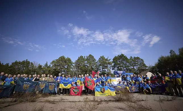 Ukrainians pose for a photo after being released in a prisoner exchange at an undisclosed location in Ukraine, Saturday Sept. 14, 2024. (Ukrainian Presidential Press Office via AP)