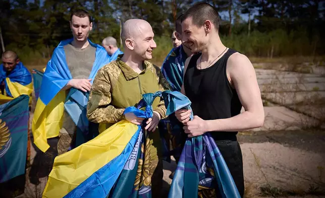 Ukrainians react after being released in a prisoner exchange at an undisclosed location in Ukraine, Saturday Sept. 14, 2024. (Ukrainian Presidential Press Office via AP)