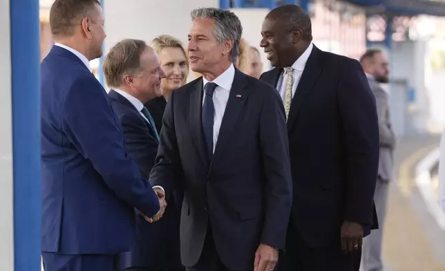 U.S. Secretary of State Antony Blinken and British Foreign Secretary David Lammy are greeted as they arrive at the train station in Kyiv, Ukraine, Wednesday, Sept. 11, 2024. (AP Photo/Mark Schiefelbein, Pool)